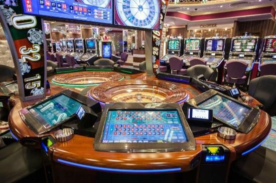 Automated roulette wheel with player terminals