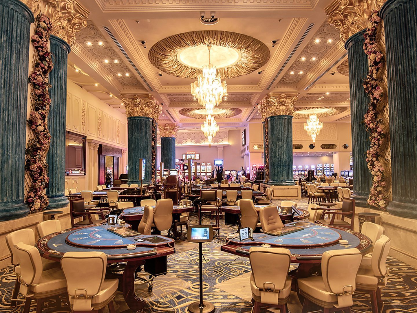 Casino gaming hall with tables and chandeliers