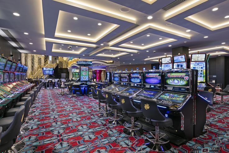 Rows of slot machines on a patterned carpet